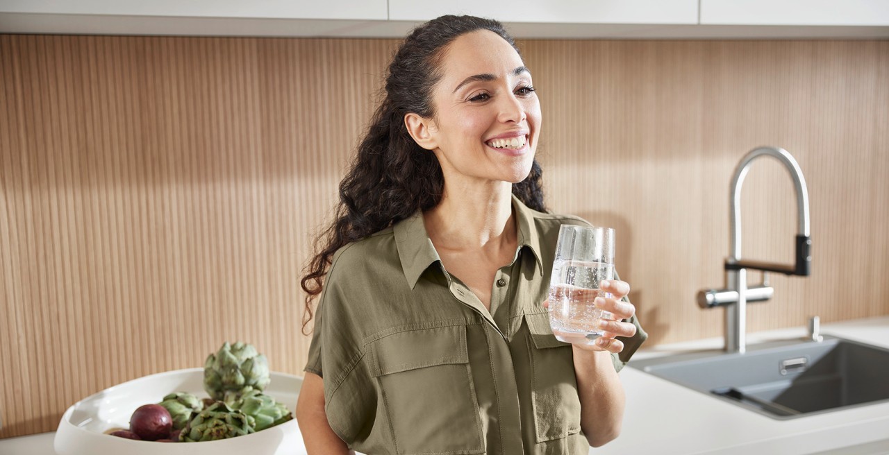 Women enjoying a glass of water from the BLANCO Choice.All